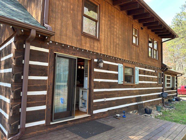 After image of stained log home wall